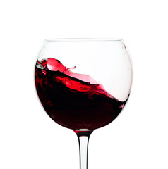 Splash of red wine in a glass isolated on  white.