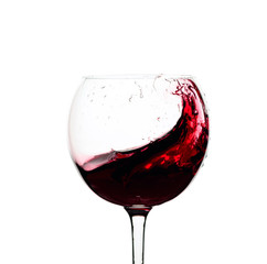 Splash of red wine in a glass isolated on  white.