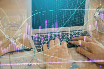Multi exposure of market chart with man working on computer on background. Concept of financial...