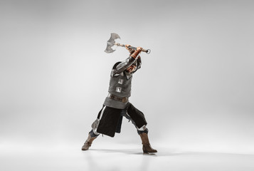 Brave armored knight with professional weapon fighting isolated on white studio background....