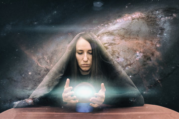Girl on the background of the starry sky. Magic ball. Paranormal abilities, clairvoyance. Elements...