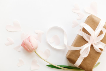 Happy womens day. Pink tulip flat lay and gift box with ribbon on white background, space for text. Stylish soft spring image. Greeting card mockup. Happy Mothers day. Romantic Valentines day