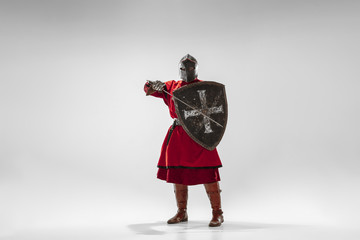 Brave armored knight with professional weapon fighting isolated on white studio background....