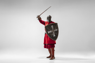 Brave armored knight with professional weapon fighting isolated on white studio background....