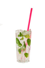 Summer drink with lime and mint leaves, frappe ice and pink straw in grain tall glass on isolated white background. Direct perspective, cool, refreshing
