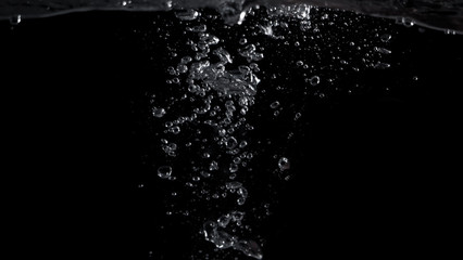 Bubbles underwater splashing and floating up and black color background which represent carbonate...