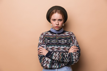 Photo of caucasian displeased woman posing at camera with hands crossed