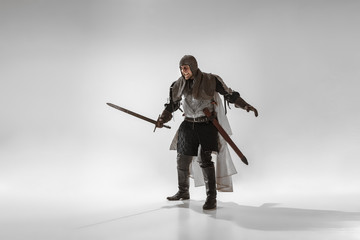 Brave armored knight with professional weapon fighting isolated on white studio background....