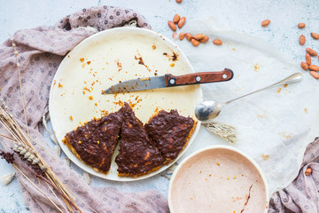 Pieces of cake crumb or chocolate pie leftover on dirty unclean plate. Vegan and healthy diet food.