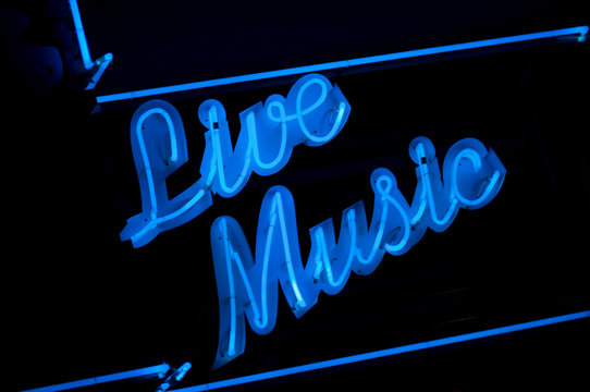 Blue Live Music neon sign nightlife message on black background at night