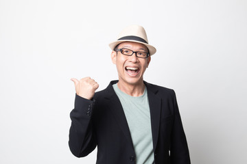 adult asian man n smile and point to copy space with her thumb.