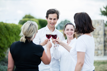 Group of friends drinking wine in a winery