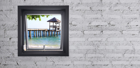Window on a white brick wall, beach view, With space to place text.