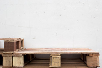 wooden shelf and wall of white bricks