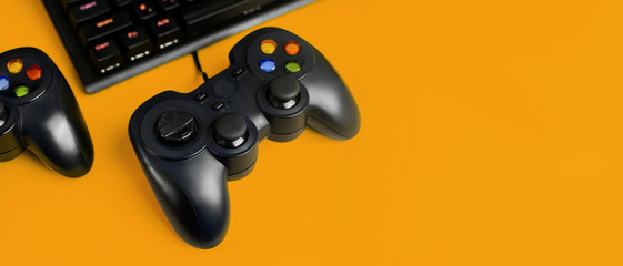.Gamepad ( joystick)  for video games  and keyboard with RGB Color  on a orange background with space for text. Game, e-sport  and gamer workspace concept. Banner format.