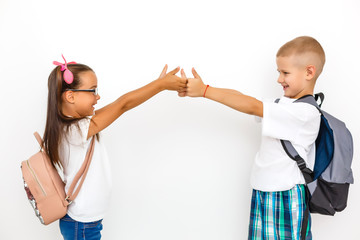 Children's fashion. Modern boy and girl posing together at studio. Education.