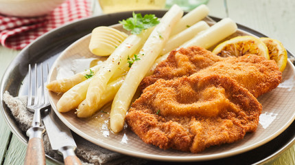 White asparagus tips served with crumbed schnitzel