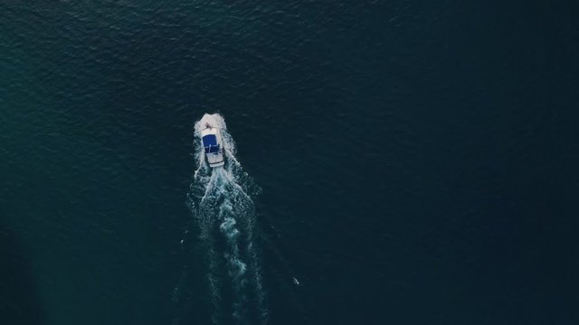 Deep sea fishing boat trip at sunrise in the Indian Ocean at Watamu, Malindi, Kenya. Top down aerial drone view