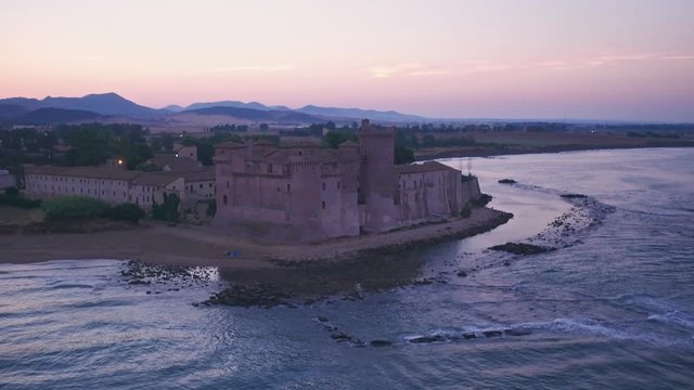 Santa Severa Beach and Castle at sunrise, Province of Rome, Italy. Aerial drone view
