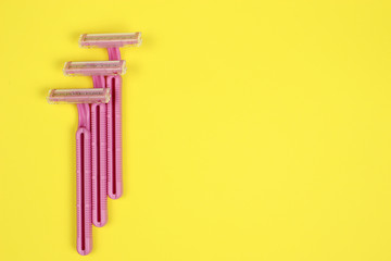 women razors on the yellow background with copy space