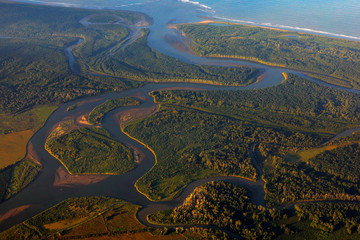 River in tropic Costa Rica, Corcovado NP. Lakes and rivers, view from airplane. Green grass in...