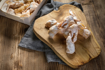 Faworki decorated with powdered sugar.