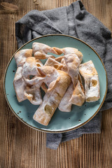 Faworki decorated with powdered sugar.