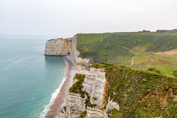 Rocks on the coast of the English channel strait. Etretat village, Normandy region, France.
