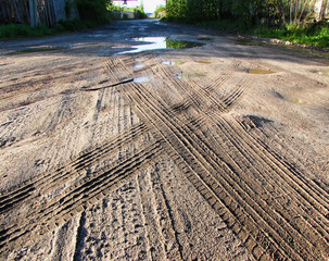 Traces of cars on a dirty road  