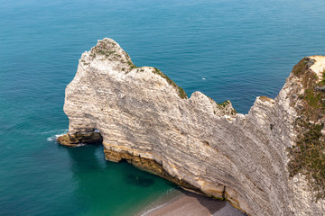 Rocks on the coast of the English channel strait. Etretat village, Normandy region, France.