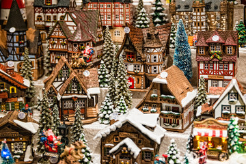 Obraz premium Toy Christmas ceramic miniature with snow-covered city. Small festive village in Berlin, Germany