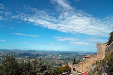Fototapeta na wymiar Sammer day time view panorama of mountain antic city, fortress. San Marino, Italy