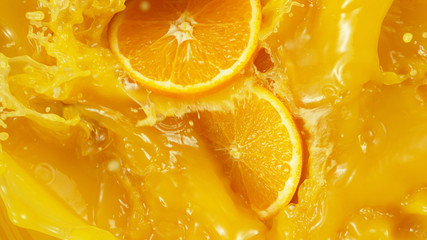 Detail of falling orange slices in juice