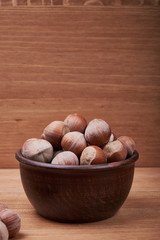 Walnut kernels and whole walnuts on rustic old wooden table