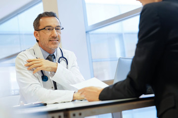 Specialist with patient in doctor's office
