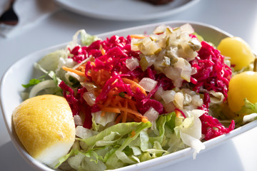 fresh salad in a bowl with lemon 