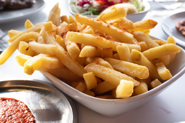 salty and spicy french fries on the table 
