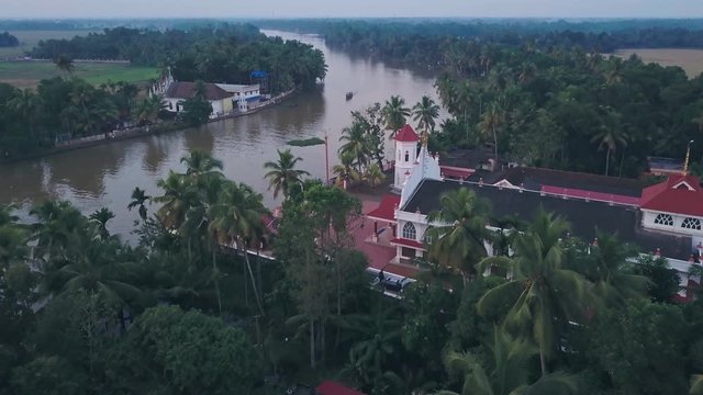 Boat tour on Kerala backwaters at Alleppey with temple in India. Aerial drone view