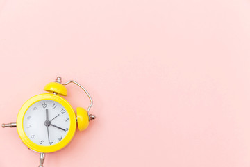 Ringing twin bell vintage classic alarm clock Isolated on pink colourful trendy pastel background....