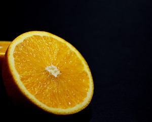 Close-up of an orange orange on a black blurred background
