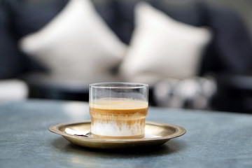 Dirty Coffee - A glass of espresso shot mixed with cold fresh milk on blurred background and copy space, Perfect drink for summer time.