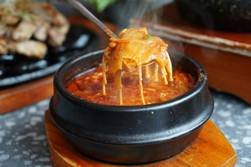 Kimchi Soup with tofu and pork belly served in clay pot, One of the most loved of all the stews in...
