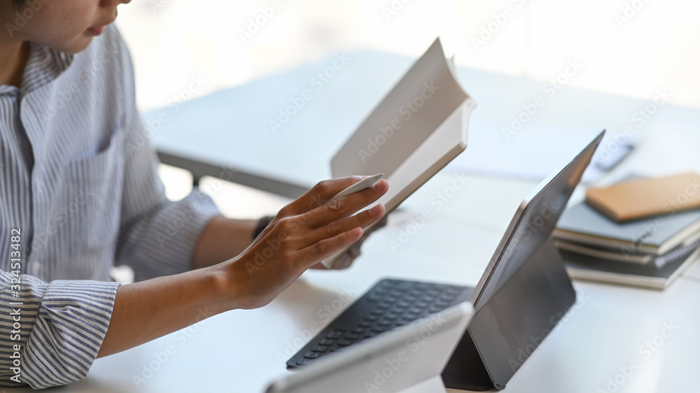 Poster cropped shot man working as accountant checking information while sitting in front computer tablet w