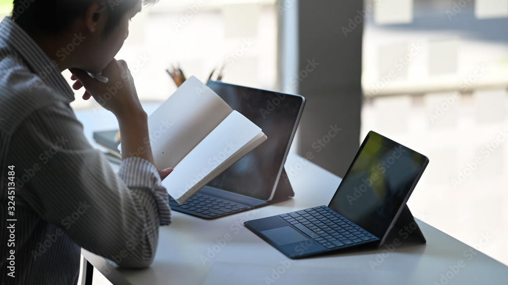 Poster closeup creative man working as accountant checking information while sitting in front computer tabl