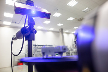 Professional 3D scanner scanning an industrial object plastic molding placed on a turntable, metrology concept