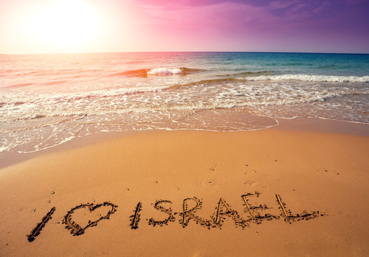 Inscription I love Israel on beach sand. Seascape at sunset in summer