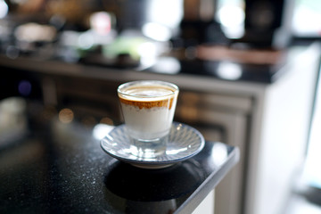 Dirty Coffee - A glass of espresso shot mixed with cold fresh milk on blurred background and copy space, Perfect drink for summer time.