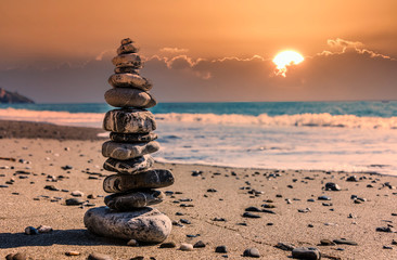 Meditative Stone Stack on a Mediterranean Beach in Southern Italy at Sunset