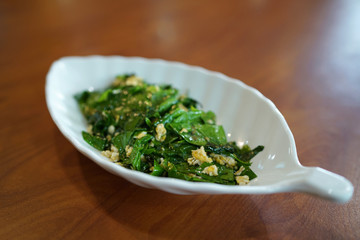 Stir-fried Baegu leaves with egg or Gnetum gnemon or Malindjo, Thai Southern traditional food style.