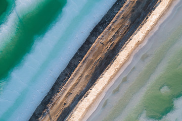 aerial view of a gravel road and salt lake